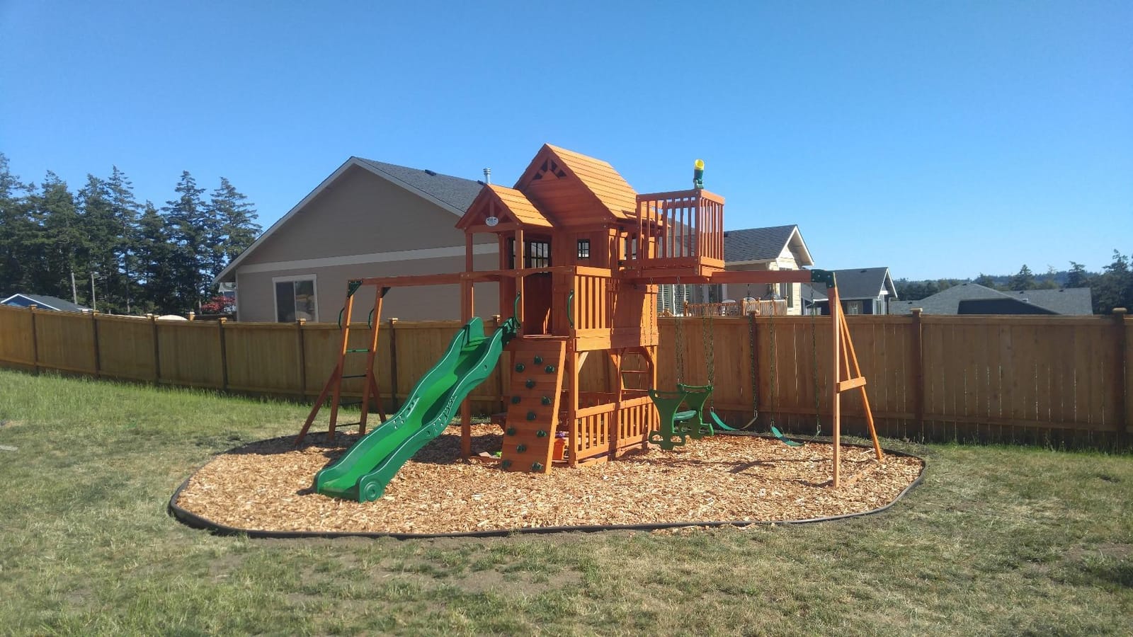 Backyard Discovery Skyfort II Cedar Wood Swing Set with Wave Slide, Raised Clubhouse, Crow's Nest, Monkey Bars, Balcony, Belt Swings, Trapeze, Rock Wall, Picnic Table, Sandbox, Ladder, Outdoor Playset customer photo 2