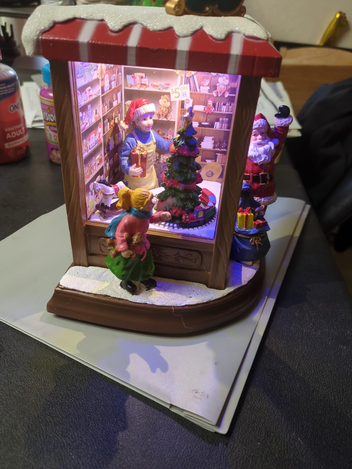 MOMENTS IN TIME Lighted Santa's Christmas Village Shop LED Lights, Music & Animation Battery Operated 8.8